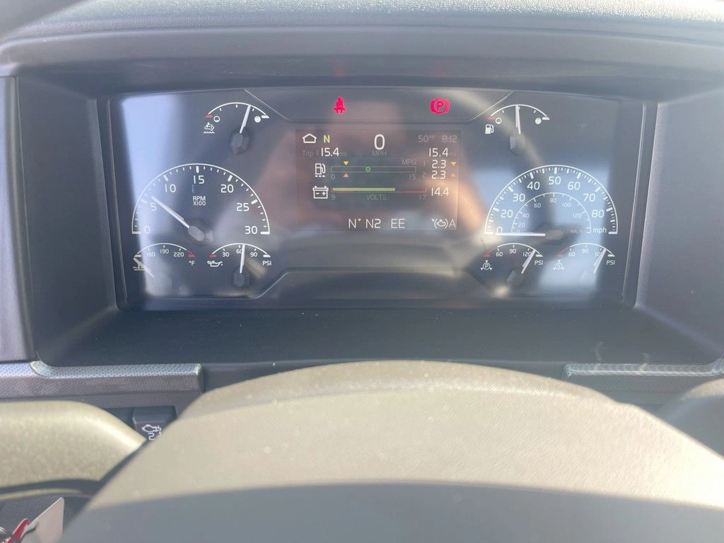 Close-up of the Volvo VNR instrument cluster behind the steering wheel.