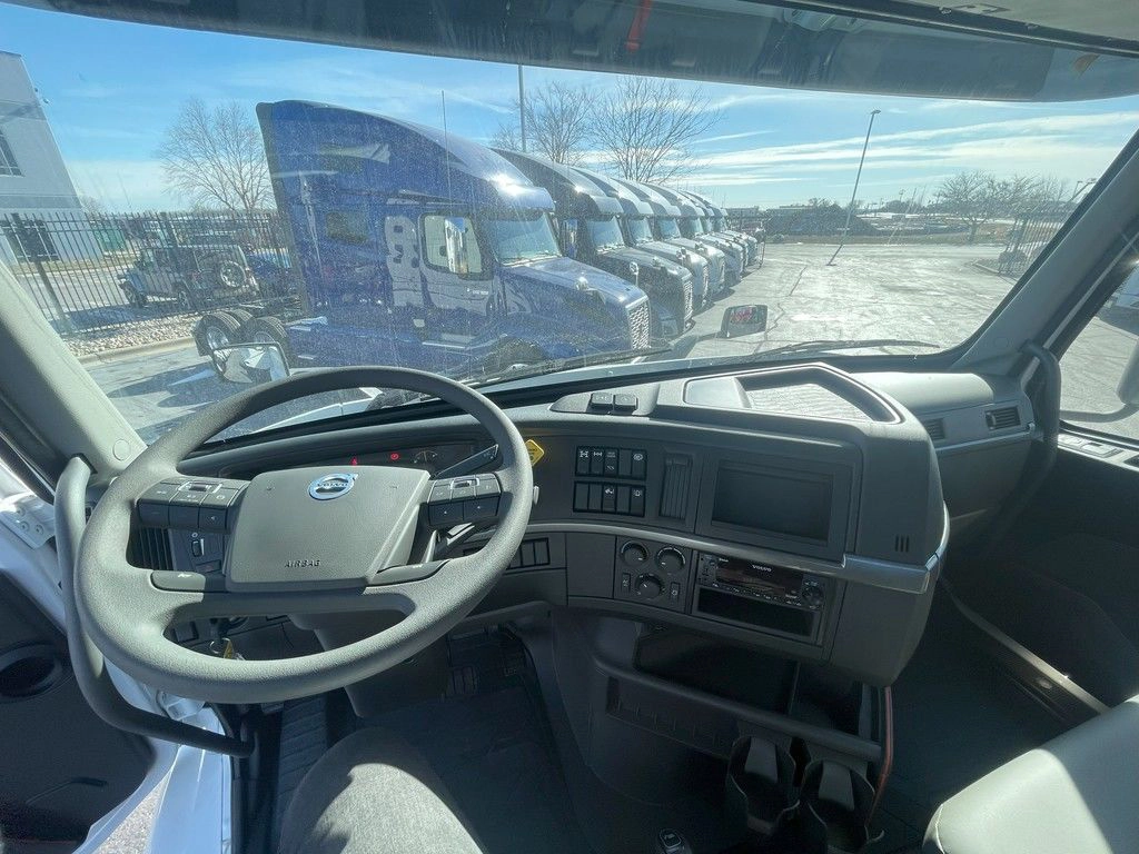 Wide view of the Volvo VNR cab interior, dashboard and steering wheel from the driver side.