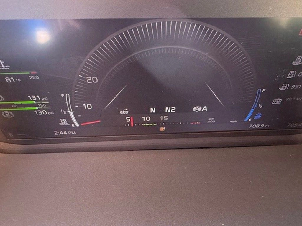 Close-up of Volvo VNL digital gauge cluster showing speedometer, fuel, DEF and transmission readouts.