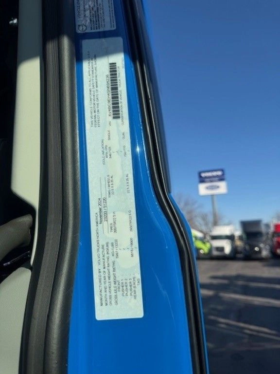 Vehicle information sticker on the inside door frame of a blue Volvo truck.