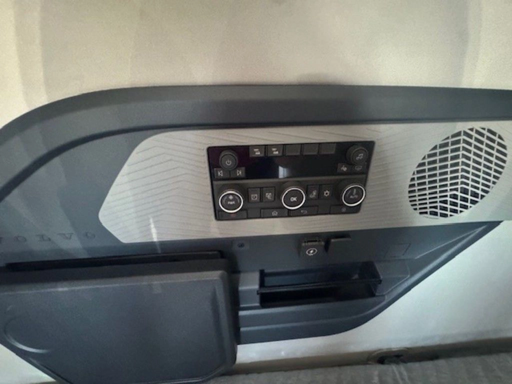 Sleeper control panel inside the Volvo VNL660 with climate controls, speaker and storage compartment.