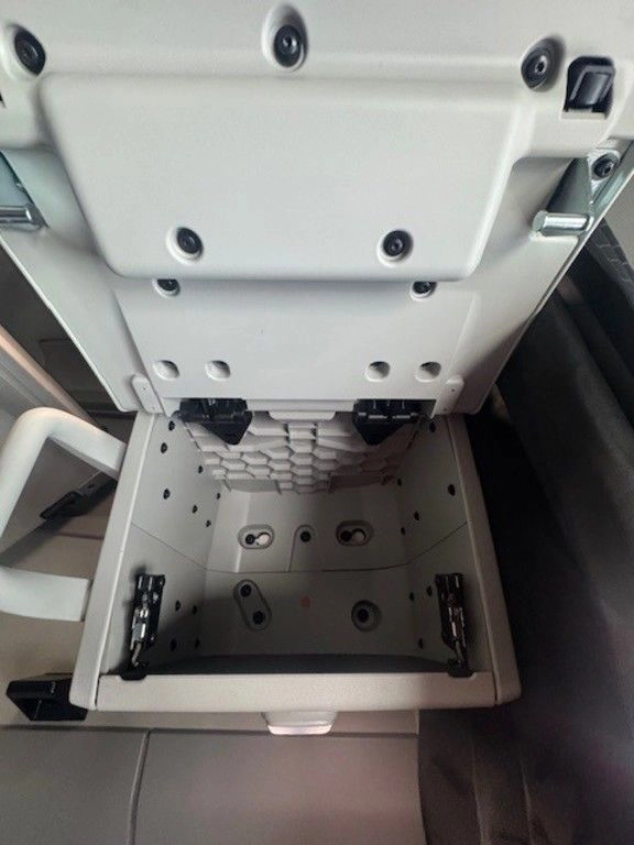 Open overhead storage compartment inside the Volvo VNL660 sleeper cab.