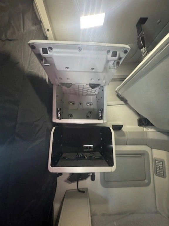 Open sleeper storage cabinet in the Volvo VNL660 showing interior shelves and compartment space.