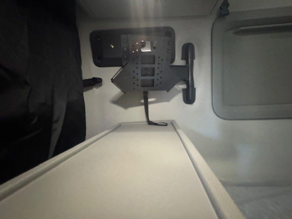 Upper sleeper storage area in the Volvo VNL660 with power outlets and rear wall compartment details.
