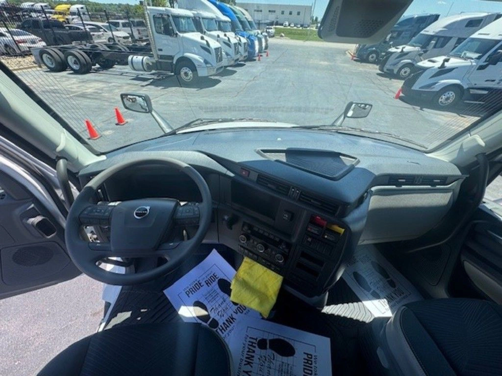 Wide driver’s seat view of the Volvo VNL660 cab showing the steering wheel, dashboard and windshield.