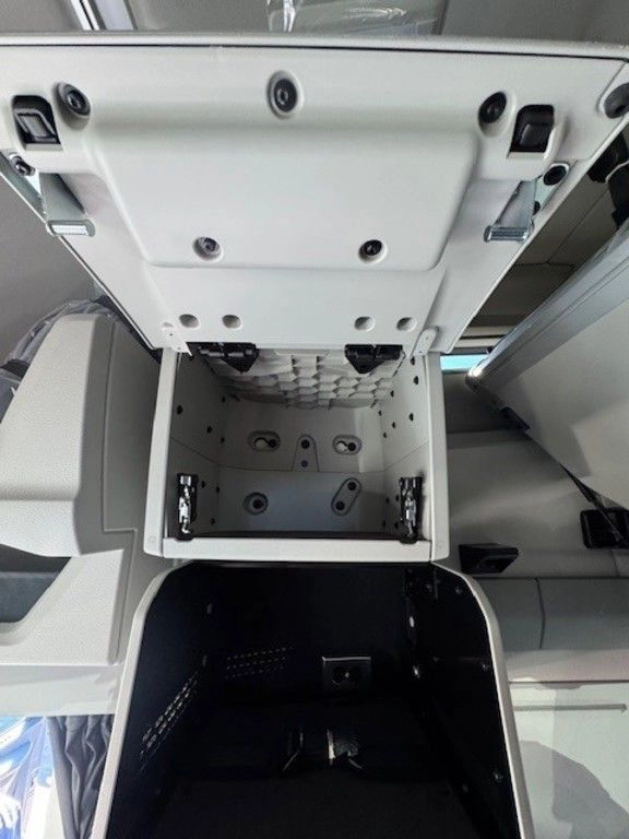 Open overhead storage compartment inside the Volvo VNL sleeper cab.