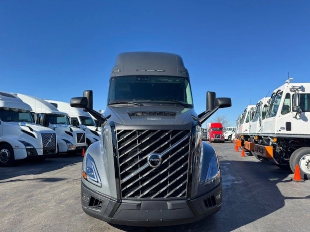 Front view of gray Volvo VNL sleeper tractor parked on the dealership lot.