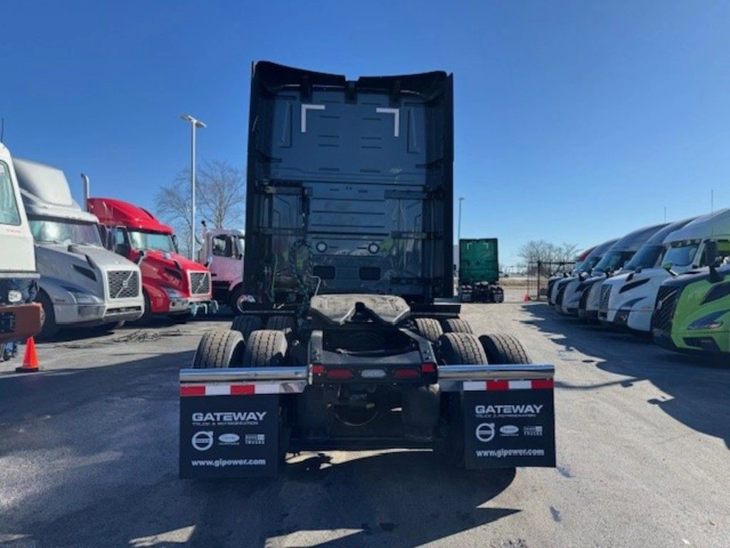 Rear view of gray Volvo VNL sleeper tractor showing fifth wheel, frame and rear mudflaps.