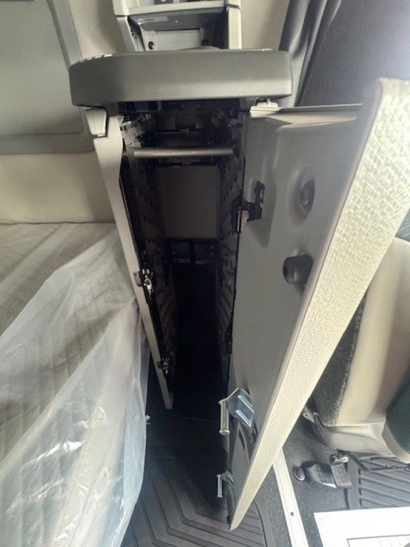 Open vertical storage cabinet inside the Volvo VNL sleeper compartment.
