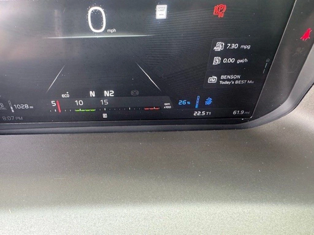 Volvo digital dashboard display showing speed, navigation indicators and vehicle status information.