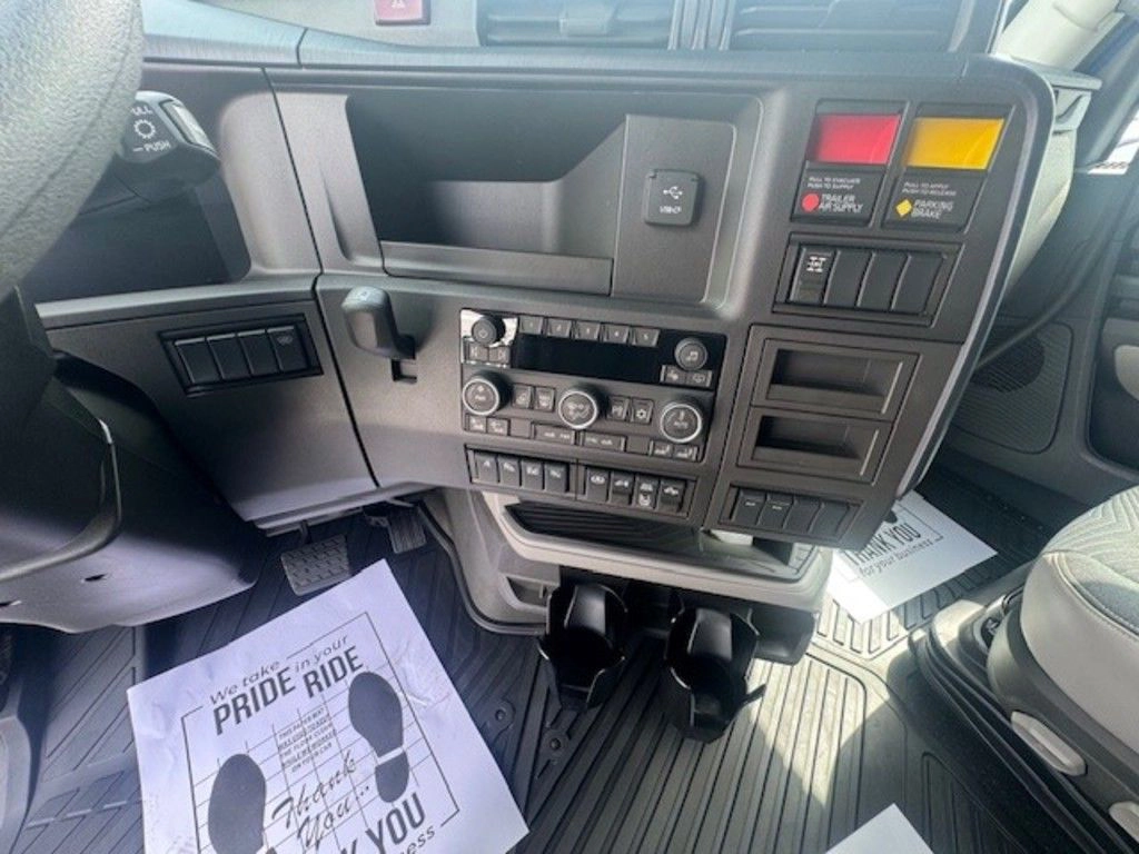 Volvo VNL dashboard controls, radio and storage panels viewed from inside the cab.