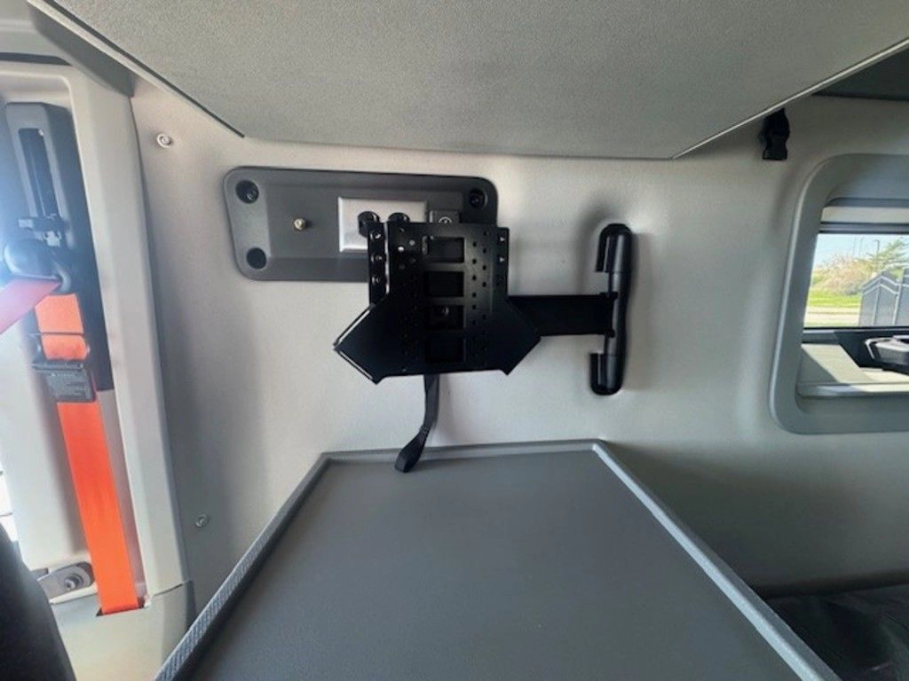 Volvo VNL sleeper wall with mounted bracket above a work surface and window for driver convenience.