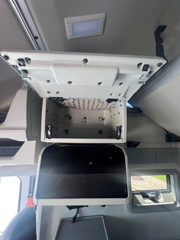 Open upper storage compartment in the Volvo VNL sleeper, showing interior space above a mounted screen.