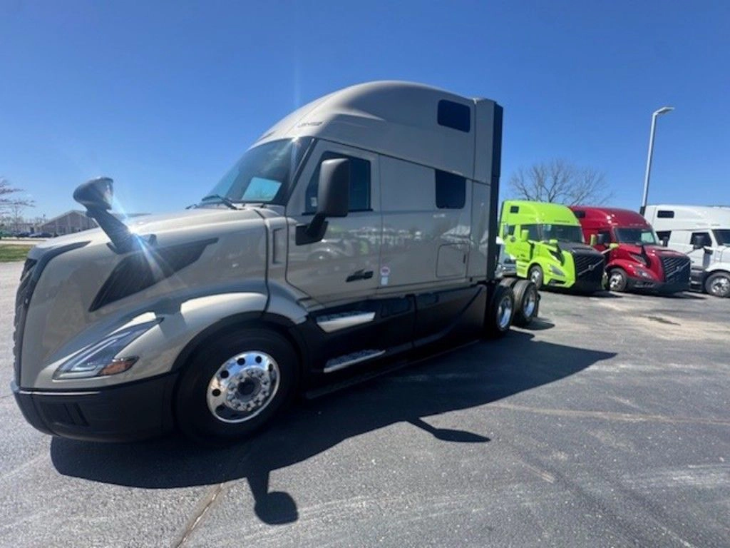 Gray Volvo VNL sleeper truck shown from the front driver side, emphasizing its aerodynamic cab and long-haul design.