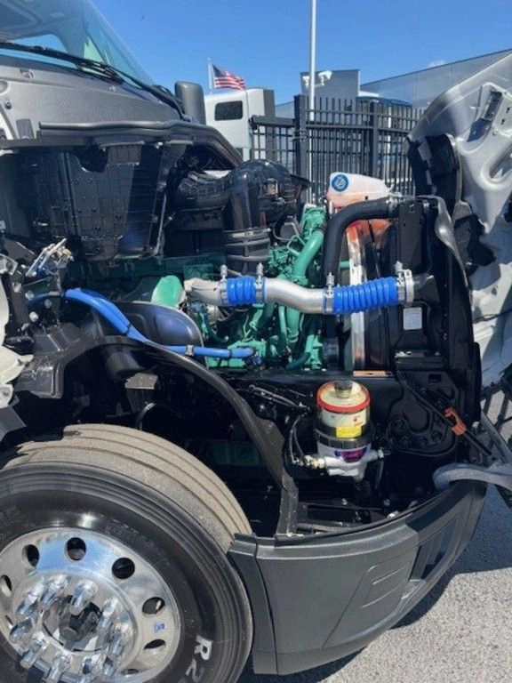 Open hood view of a Volvo VNL engine bay, highlighting the truck’s powertrain and service access.