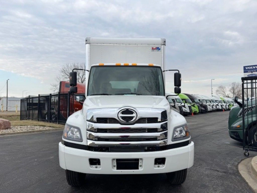 Front view of the white Hino L6 box truck showing the grille, windshield and full-height cargo body.