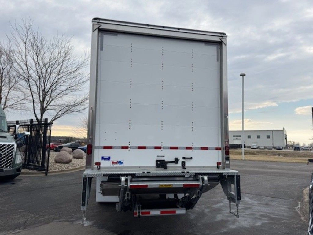 Straight rear view of the Hino L6 cargo box with closed rear door, liftgate and stabilizer arms.