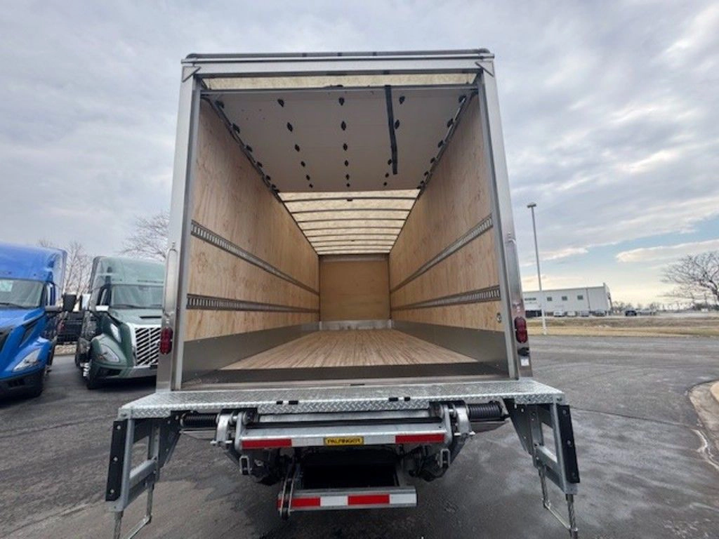 Open rear cargo area of the Hino L6 box truck, showing the clean wood-lined interior and liftgate platform.