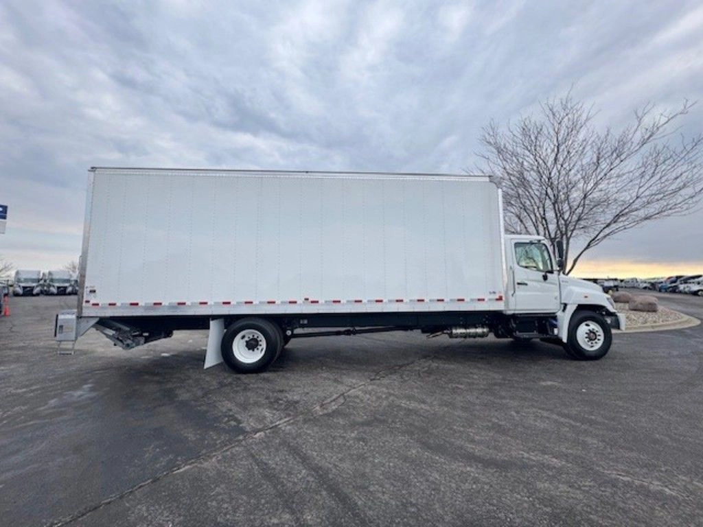 Full passenger-side view of the Hino L6 box truck, highlighting the long cargo body and single rear axle.