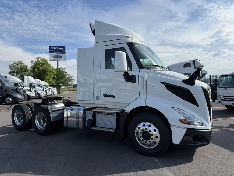 2027 Volvo VNR64T300 day cab semi truck in white, passenger-side front three-quarter view, parked at a Volvo dealership lot