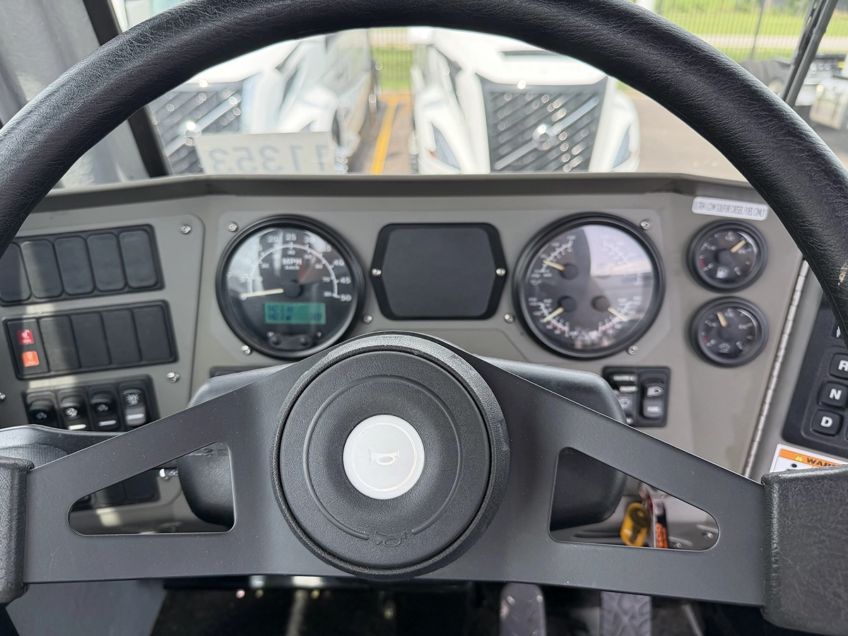 Close-up of the dashboard gauges and steering wheel inside a 2024 TICO Pro-Spotter yard truck cab.