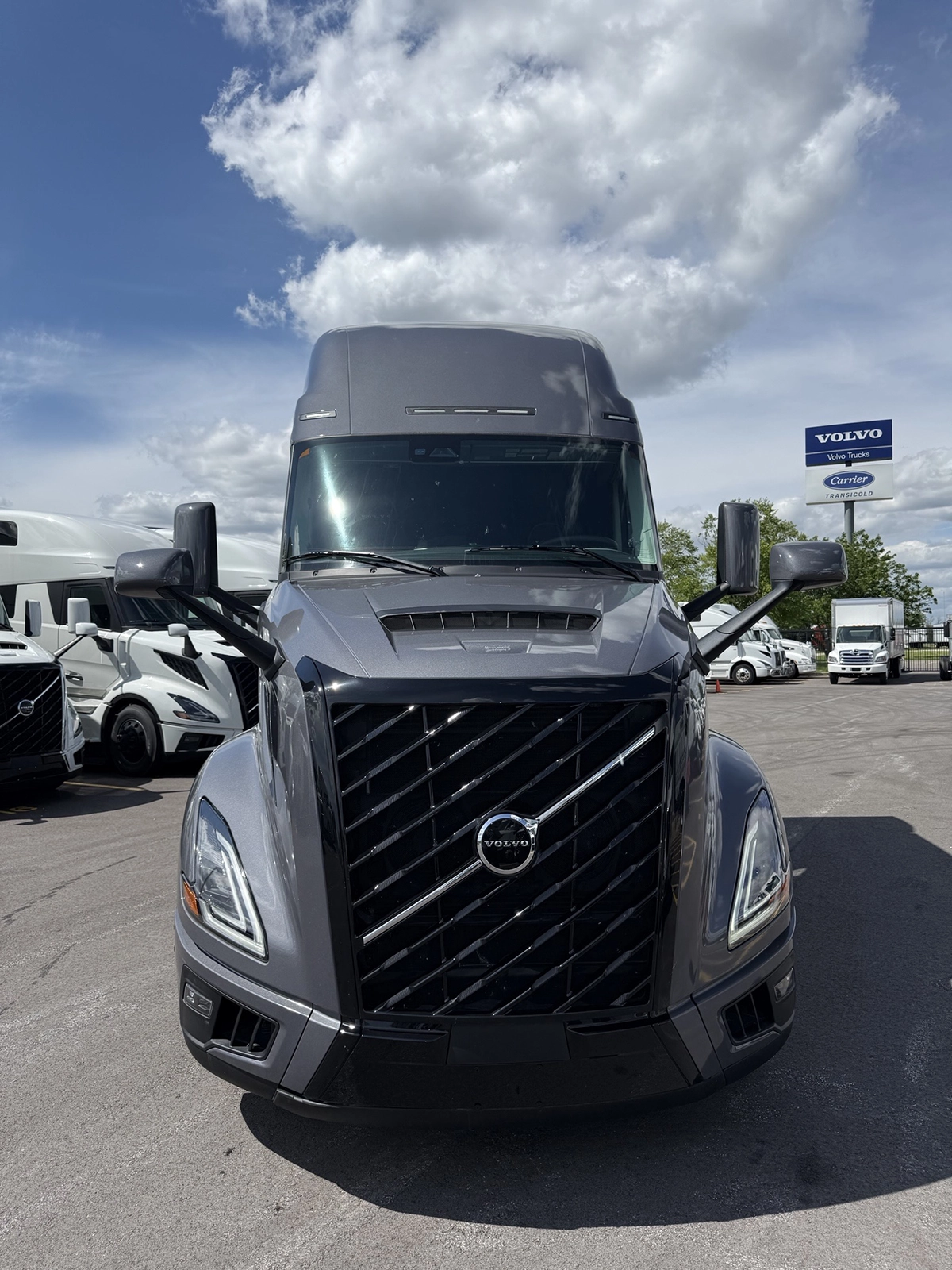 Front view of a gray 2025 Volvo VNL64T860 with a black diagonal-slat grille, Volvo badge, and dual side mirrors, parked at Gateway Truck & Refrigeration.