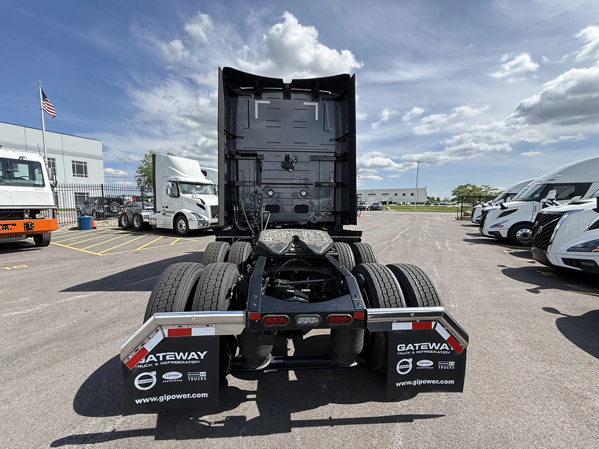 Rear view of a gray 2025 Volvo VNL64T860 showing the fifth wheel, tandem axles, and Gateway Truck & Refrigeration mud flaps.