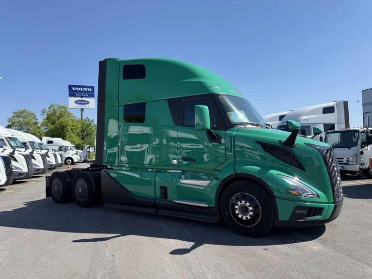 Front passenger side view of a green 2025 Volvo VNL64T860 sleeper semi truck with a high-roof sleeper cab and tandem rear axles.