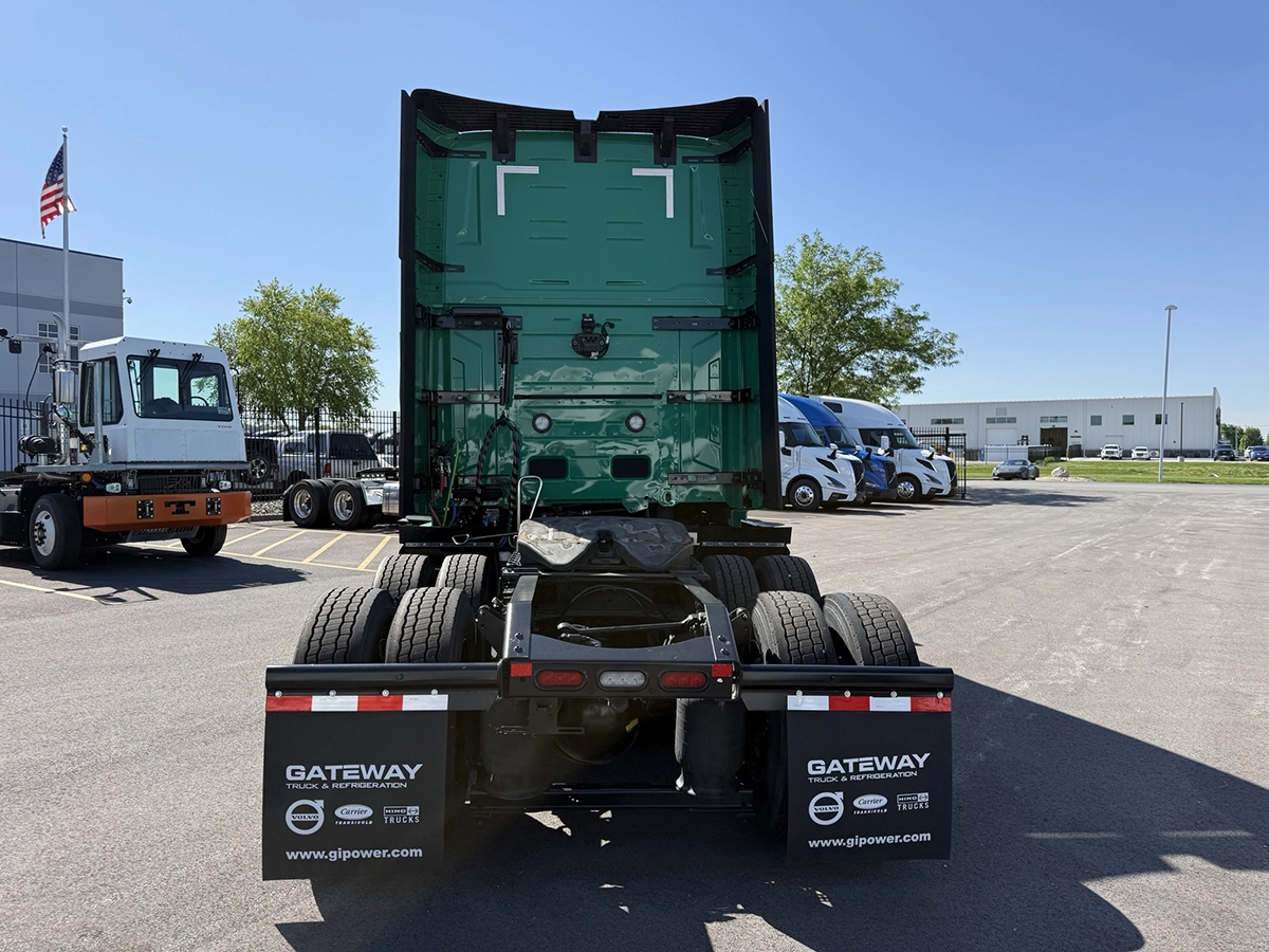 Rear view of a green 2025 Volvo VNL64T860 showing the fifth wheel, tandem axles, and Gateway Truck & Refrigeration mud flaps.