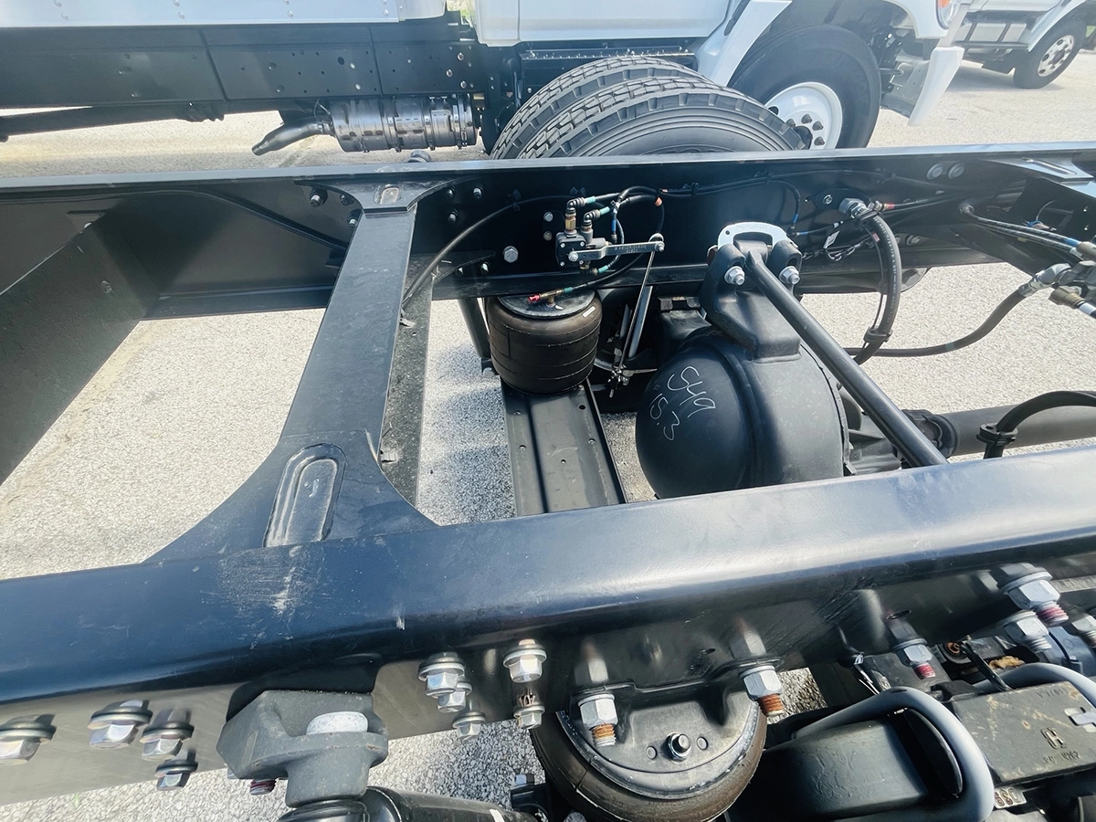 Close-up of the rear air ride suspension and tandem axles on a 2025 Volvo VNL64T860, with a 3.49 gear ratio marked on the differential housing.