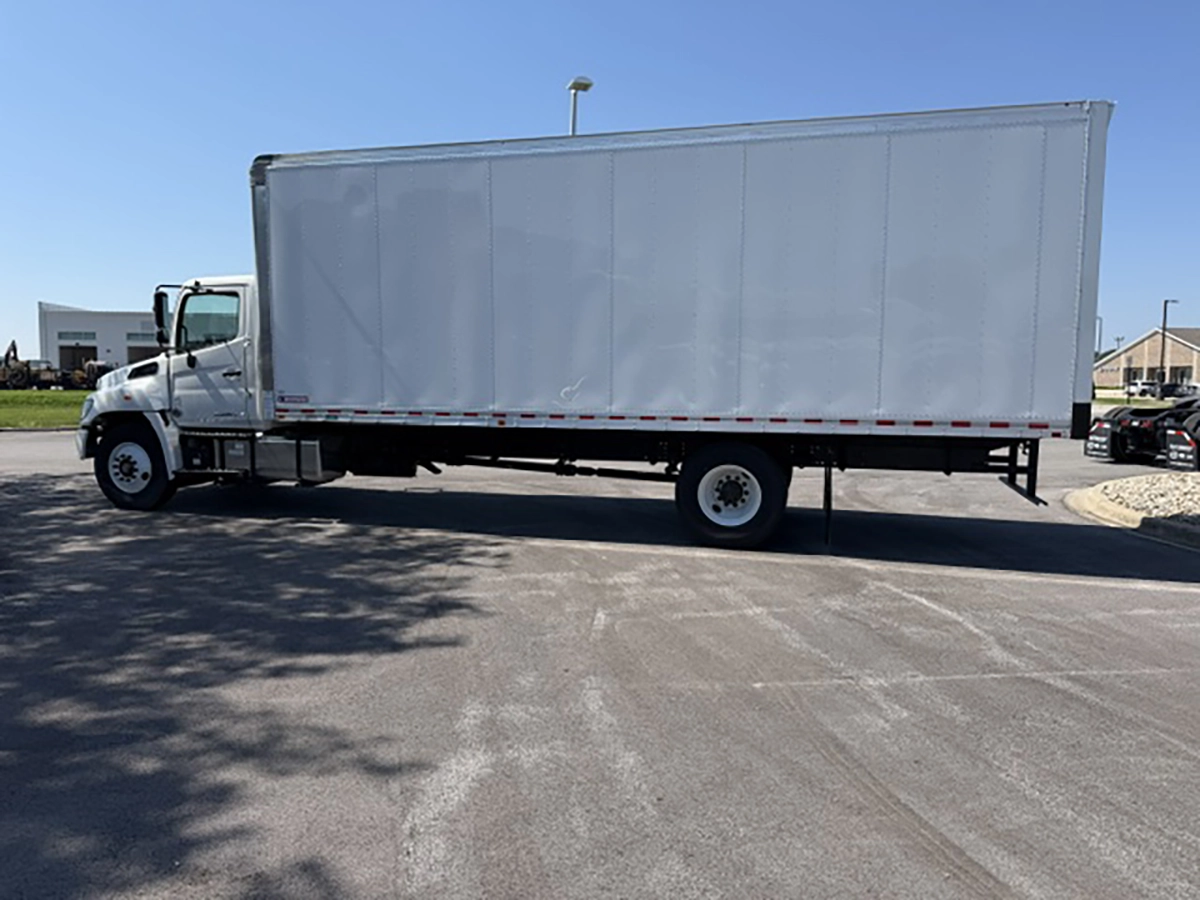 Passenger side view of a white 2026 Hino L6 box truck showing the full length of the Morgan dry van body.